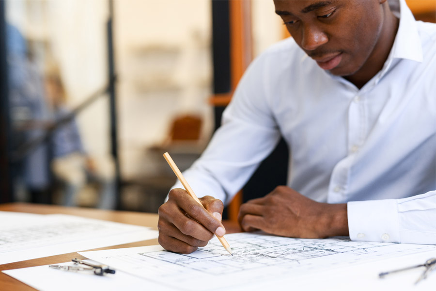 Surety Bonds - Business Man Working on Building Plans