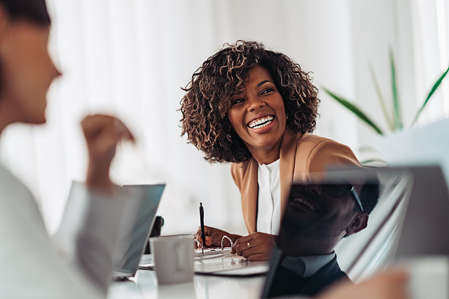 Client Center - Female Executive Laughing During Business Meeting