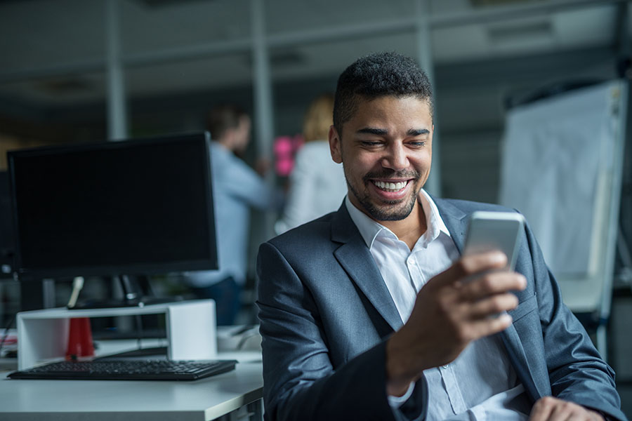 Contact - Man In Suit Smiling at His Phone