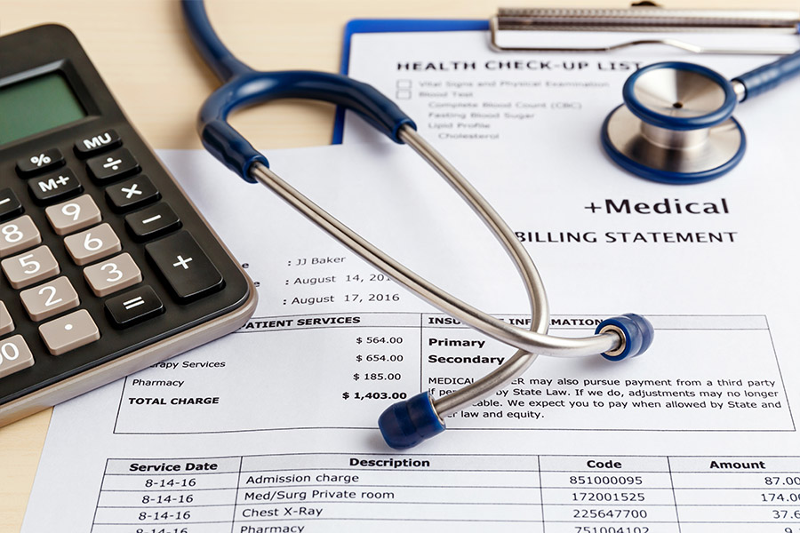 Logicomp Medical Bill Review - Stethoscope, Calculator, and Documents Spread Out on a Table